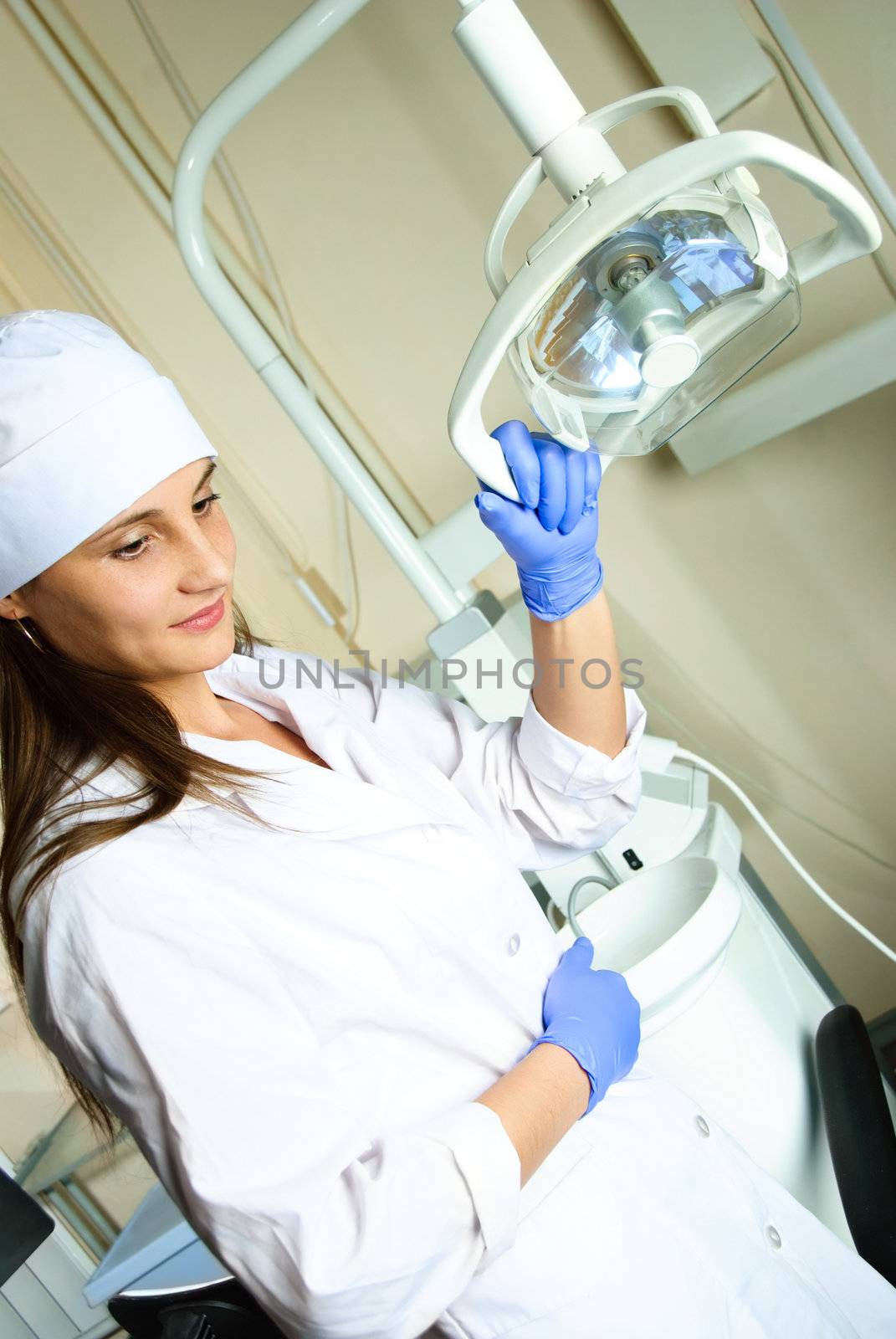 portrait of a young attractive dentist at workplace