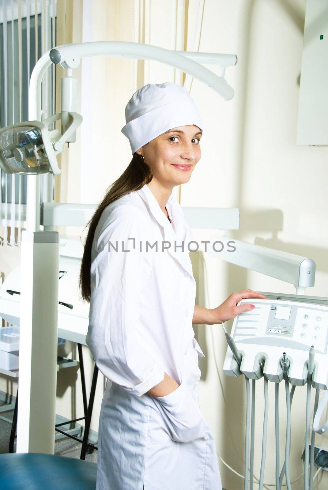portrait of a young attractive woman-dentist at workplace