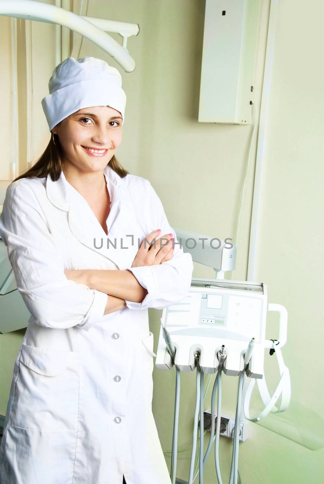portrait of a young attractive dentist in her office