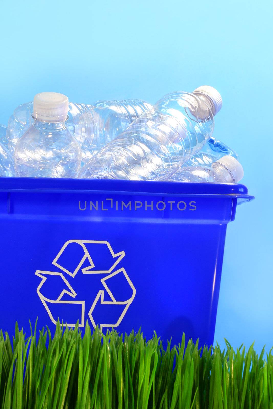 Bottles in recycling container bin in the grass