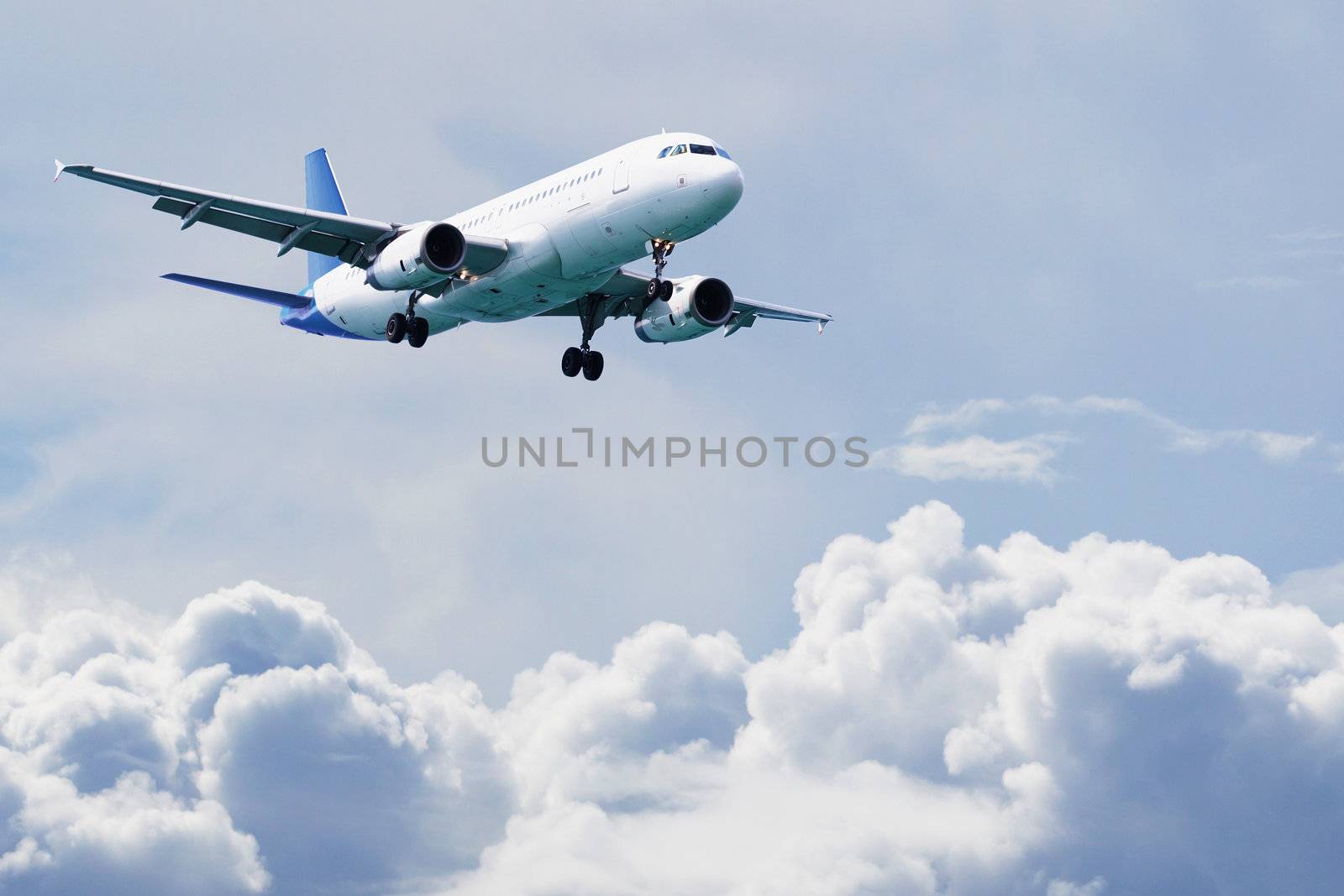 Passenger airliner flies above the clouds by pzaxe