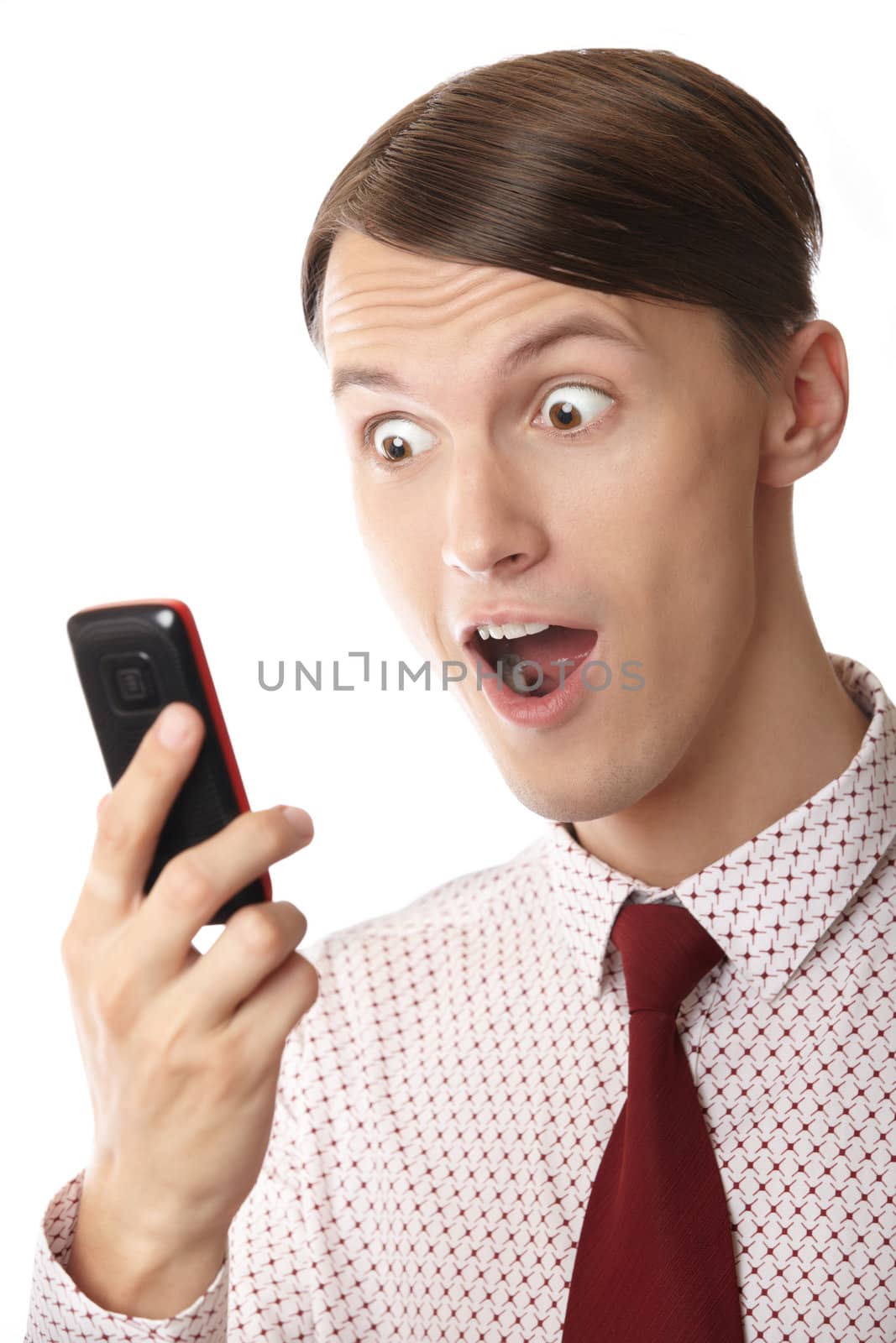 Emotional astonished businessman holding cell phone on a white background