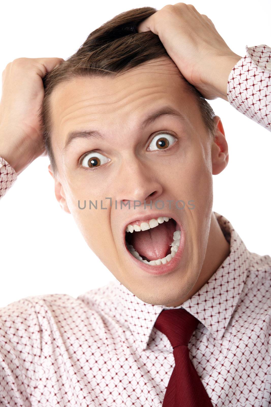 A businessman in trouble screaming on white background