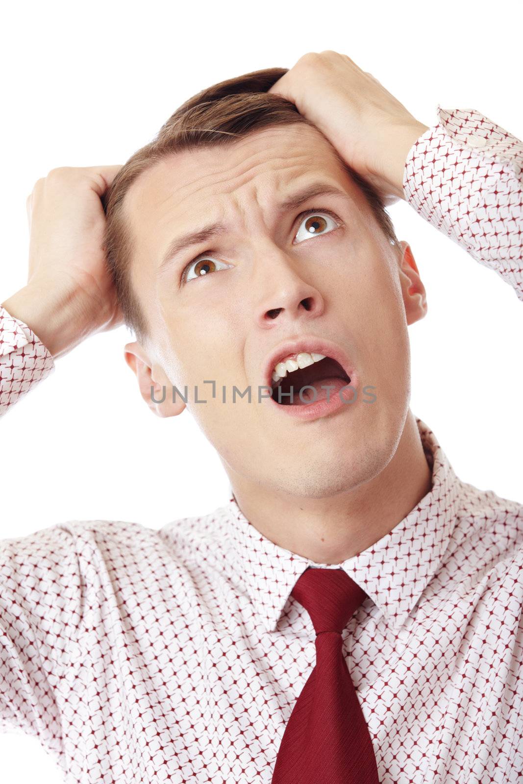 A businessman in trouble screaming on white background