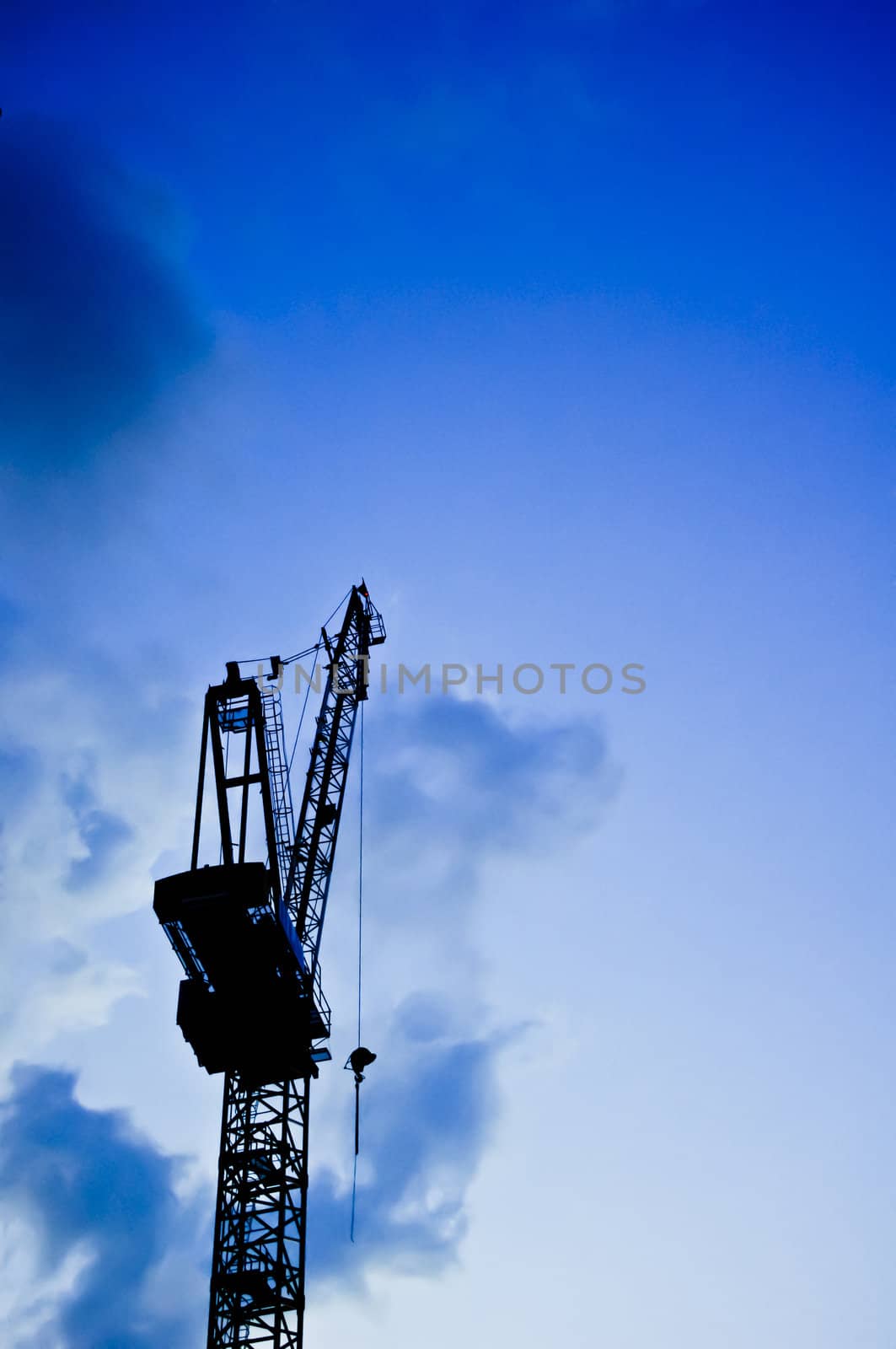 a construction crane silhouette in twilight.