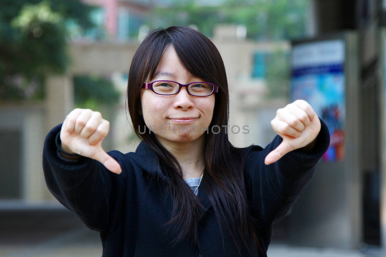 Asian woman thumbs down