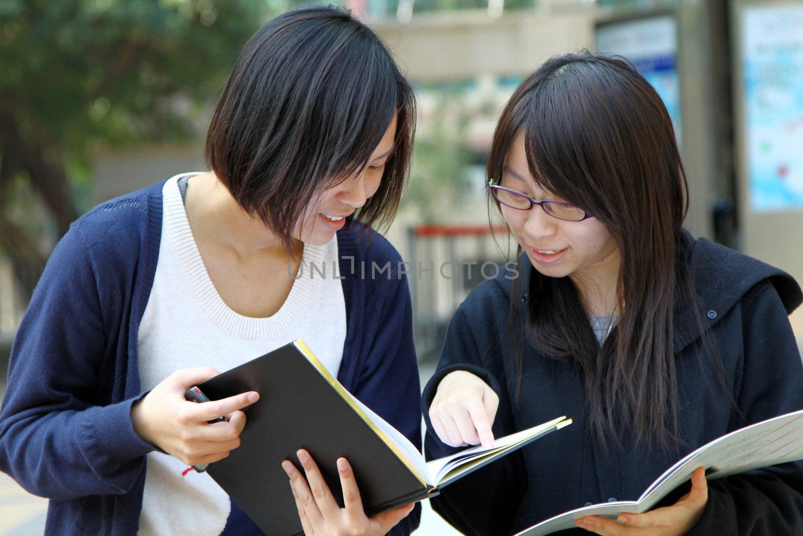 Asian students studying and discussing in university