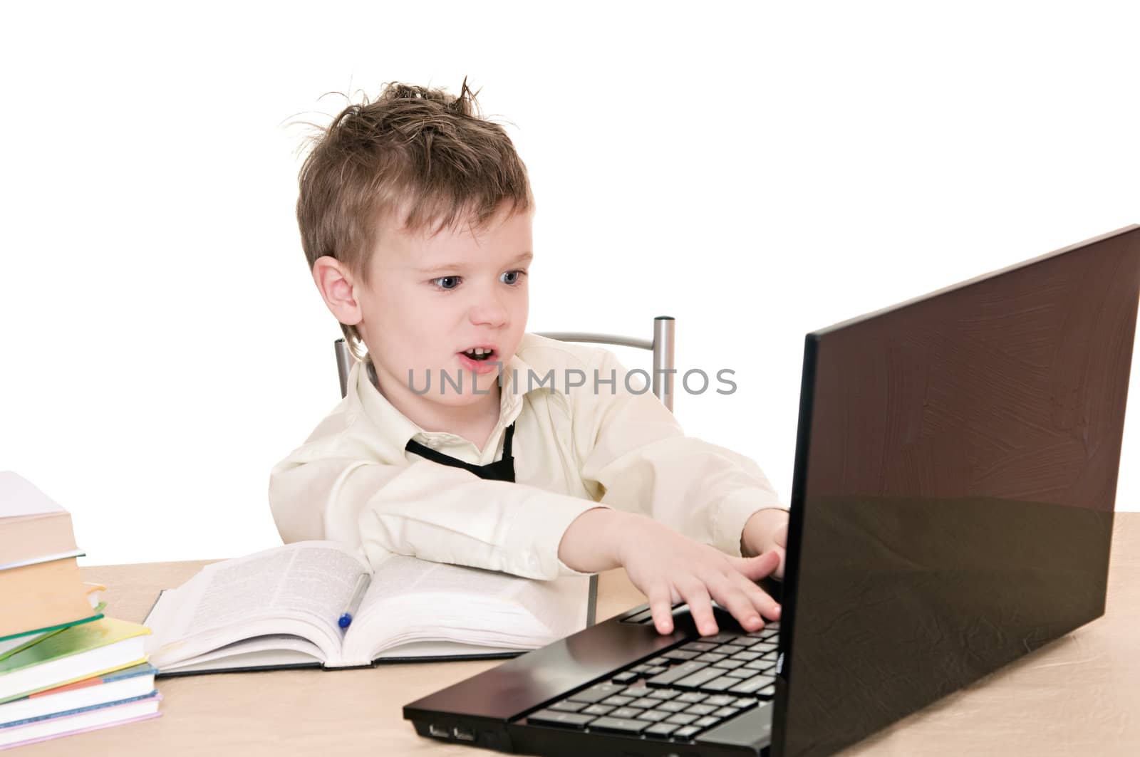 a boy pupil works on the laptop