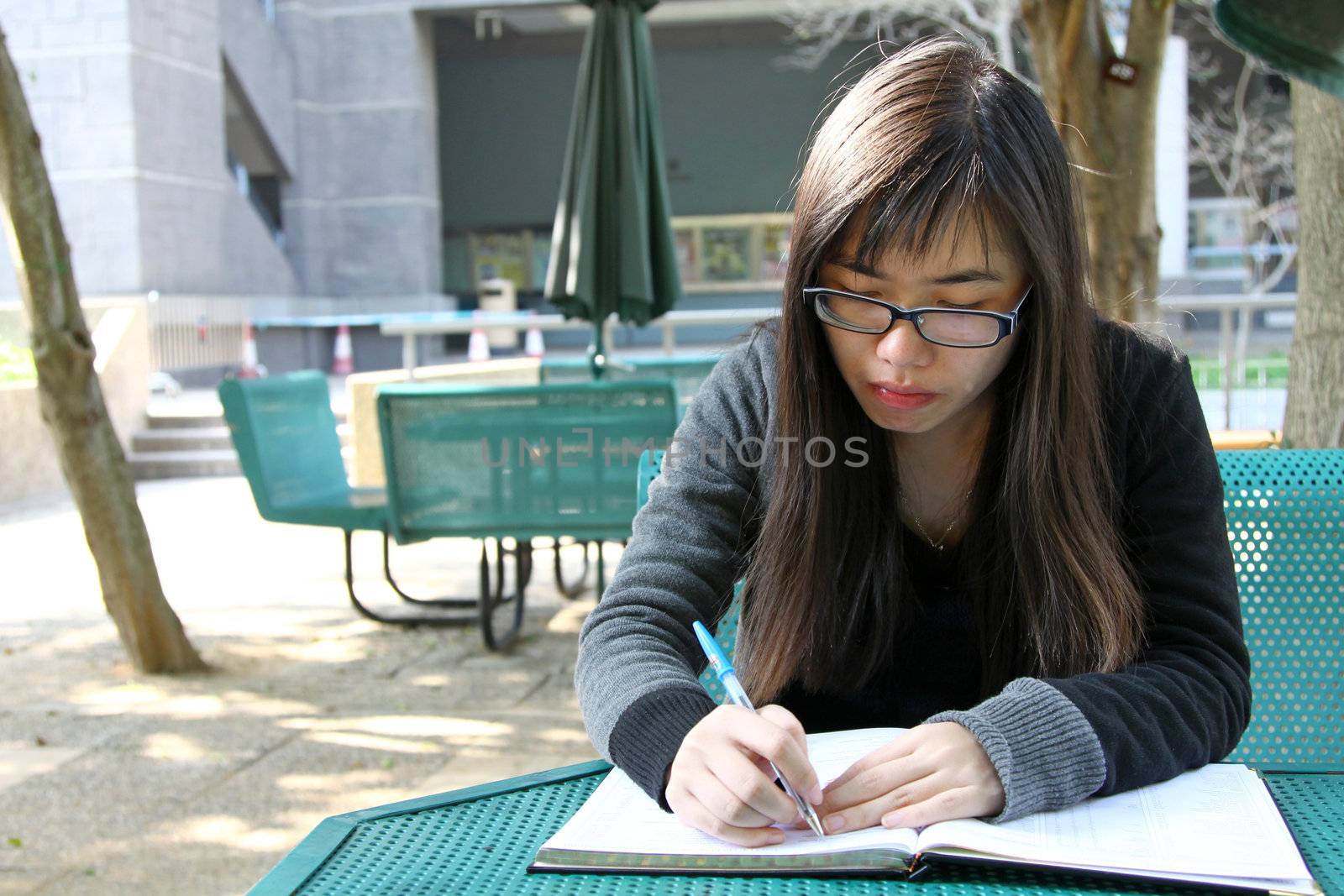 Asian girl studying in university by kawing921