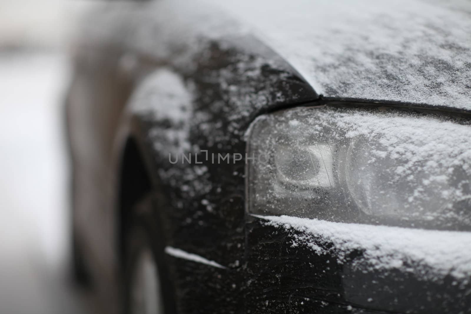 fragment of the car, front view, snow ice freezing speed