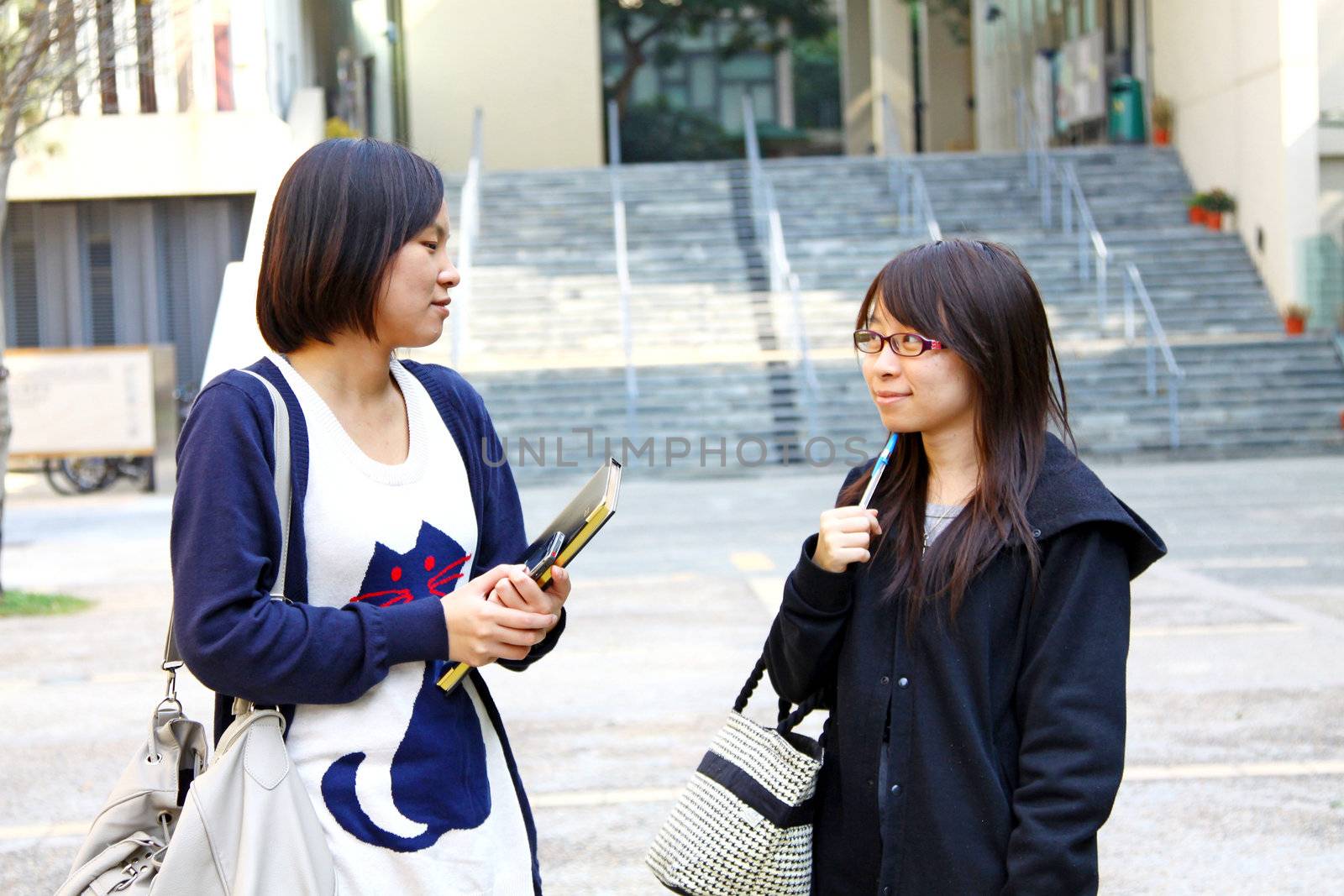 Asian students studying and discussing in university