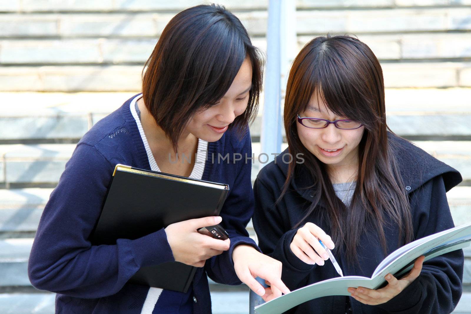 Asian students studying and discussing in university