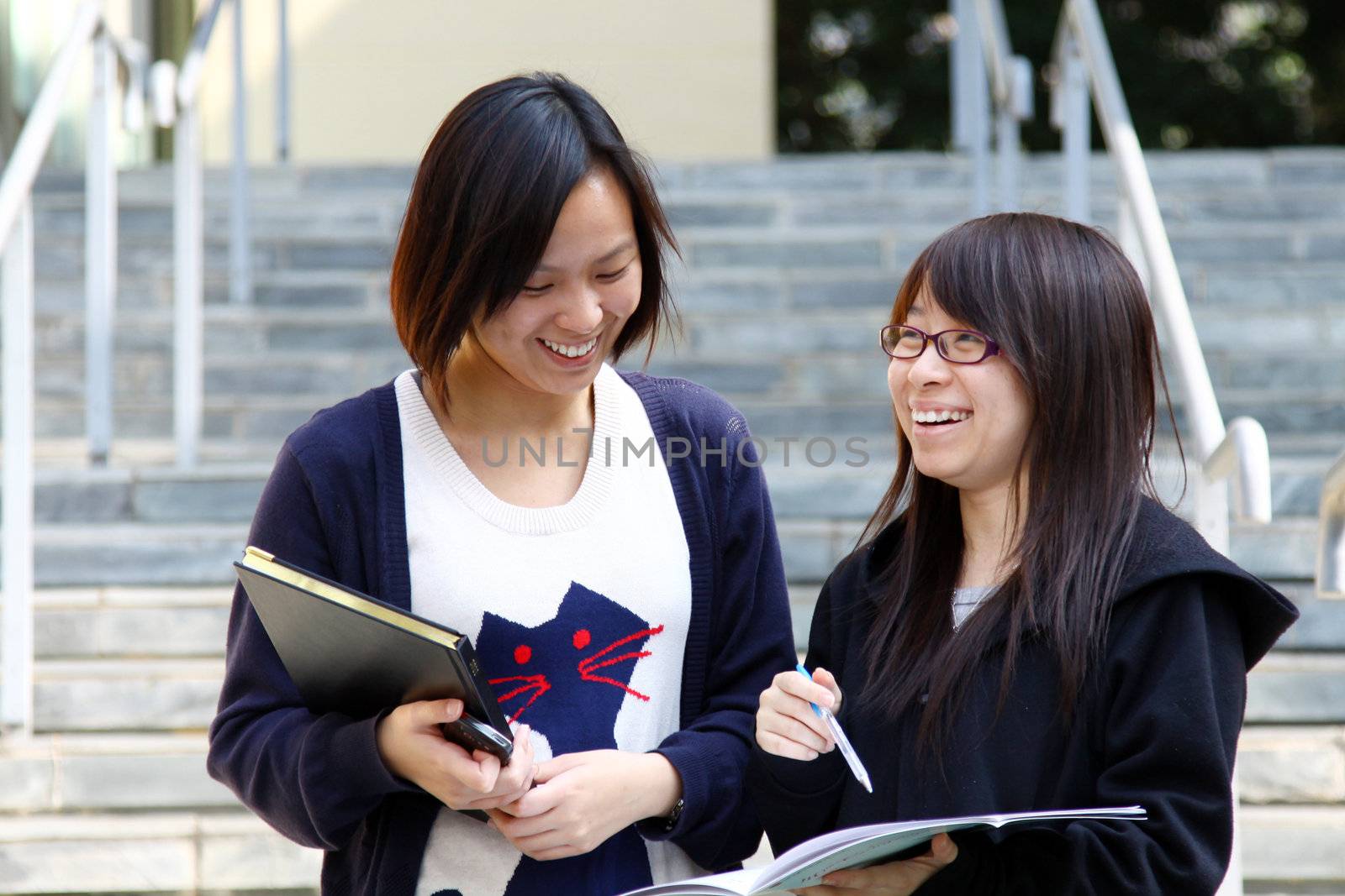 Asian students studying and discussing in university