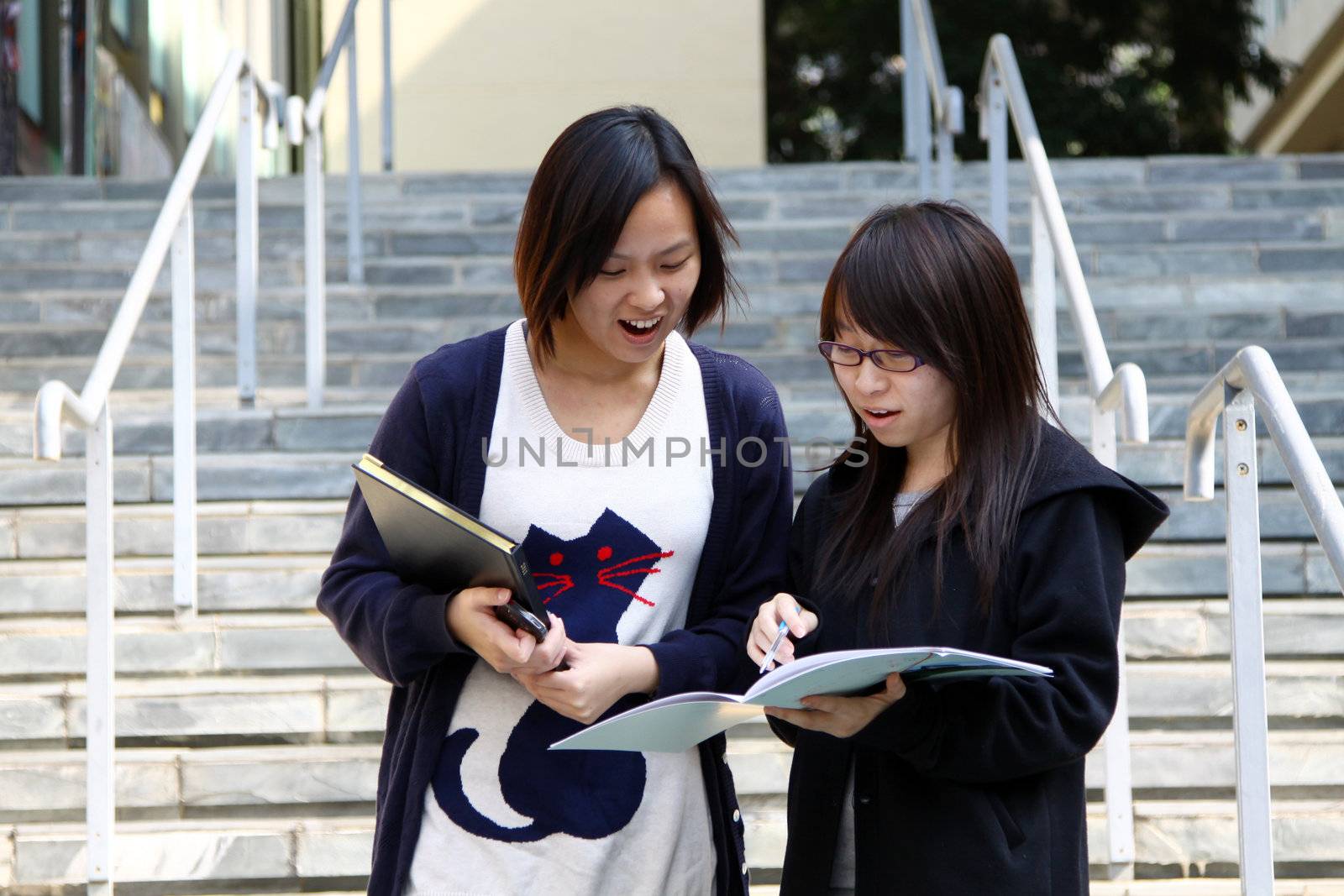 Asian students studying and discussing in university