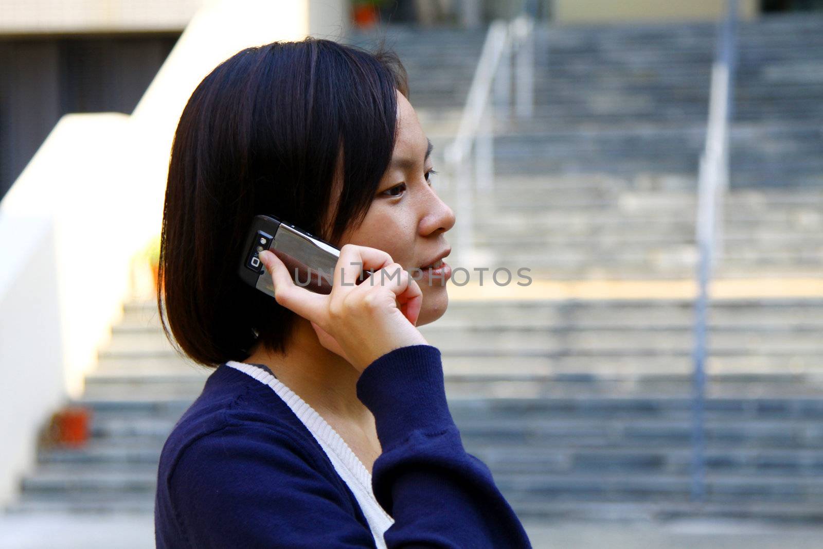 Asian woman using mobile phone and talking