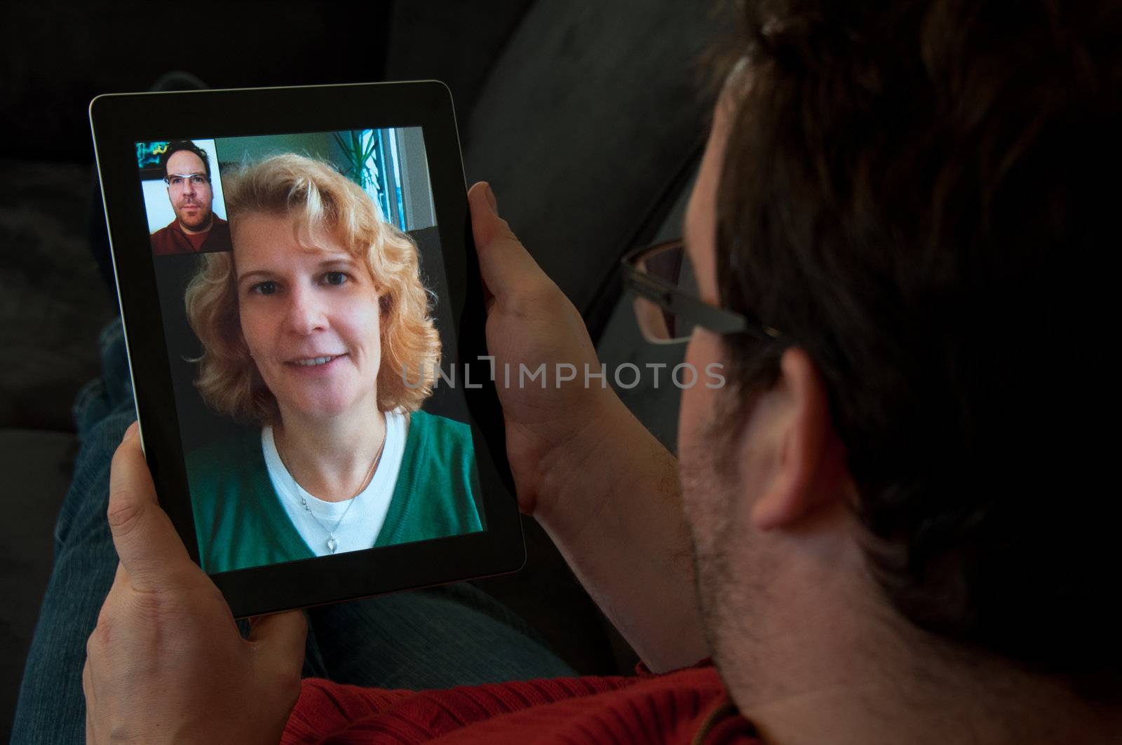 Middle-aged man using video telephony on digital tablet pc