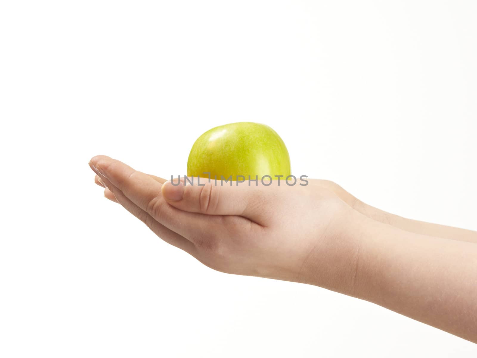 Apple in the palms og childs hands - on white background