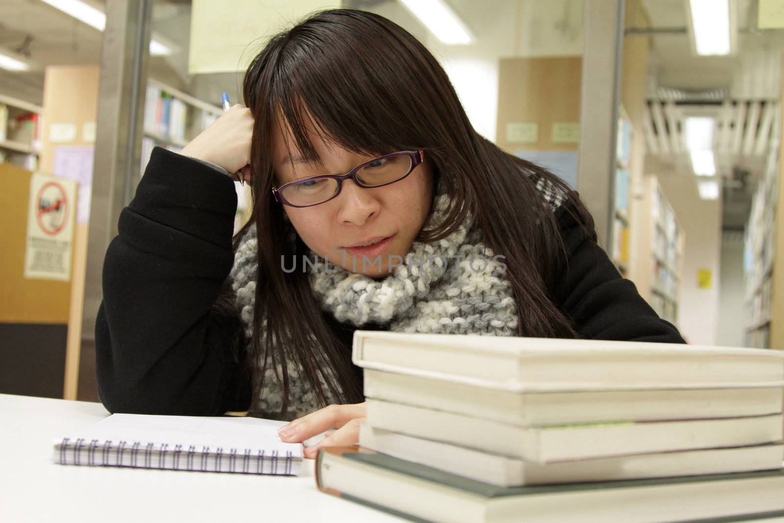 Asian university student in library