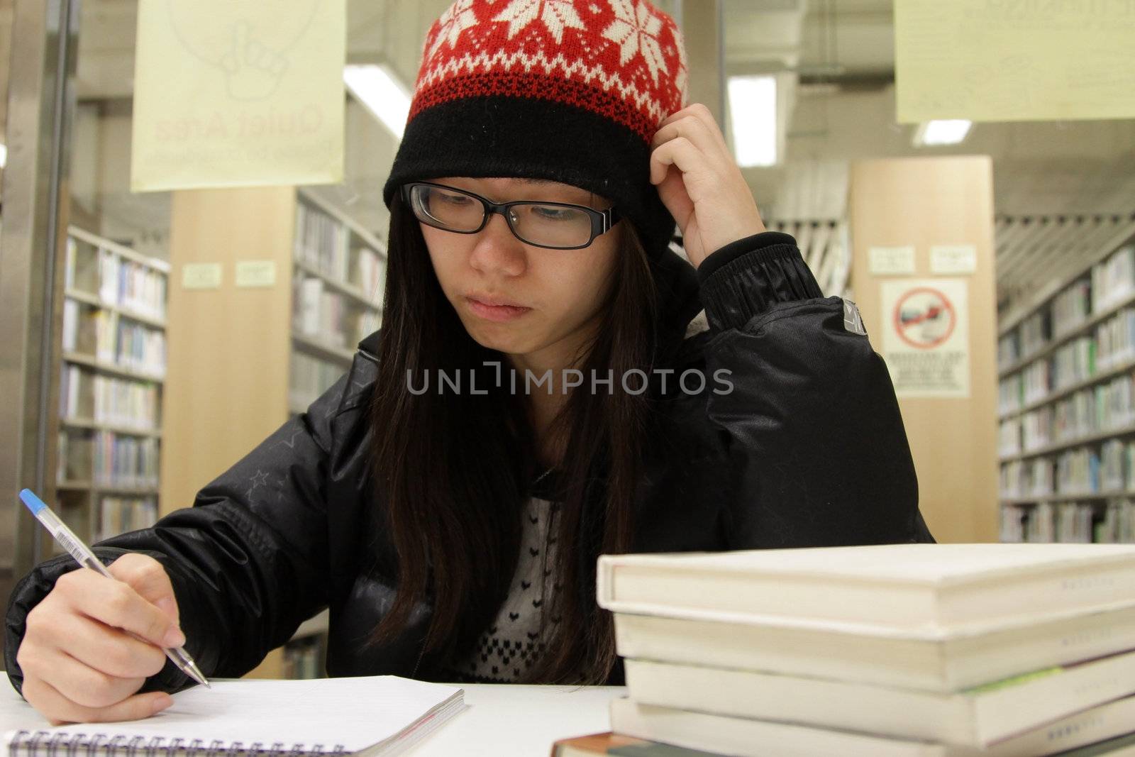 Asian woman studying in library