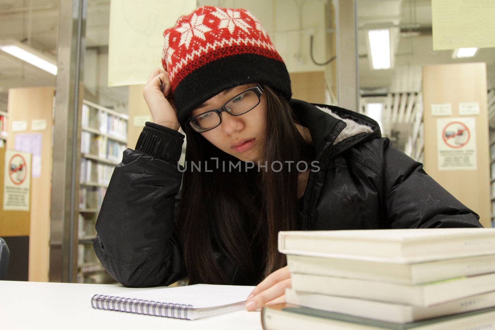 Asian woman studying in library by kawing921