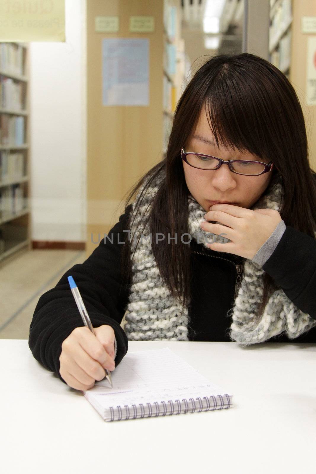 Asian woman studying in library