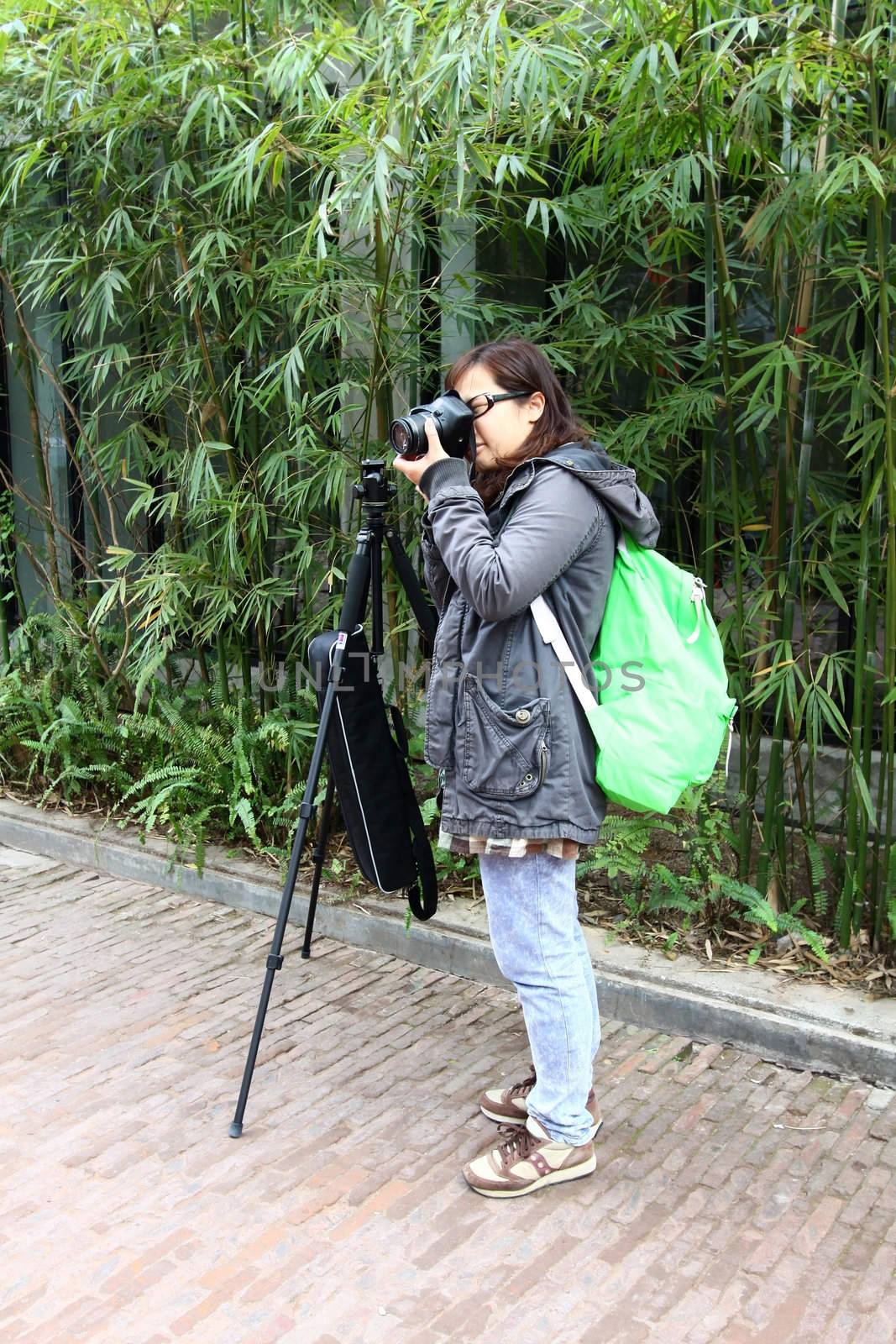 Female photographer with tripod