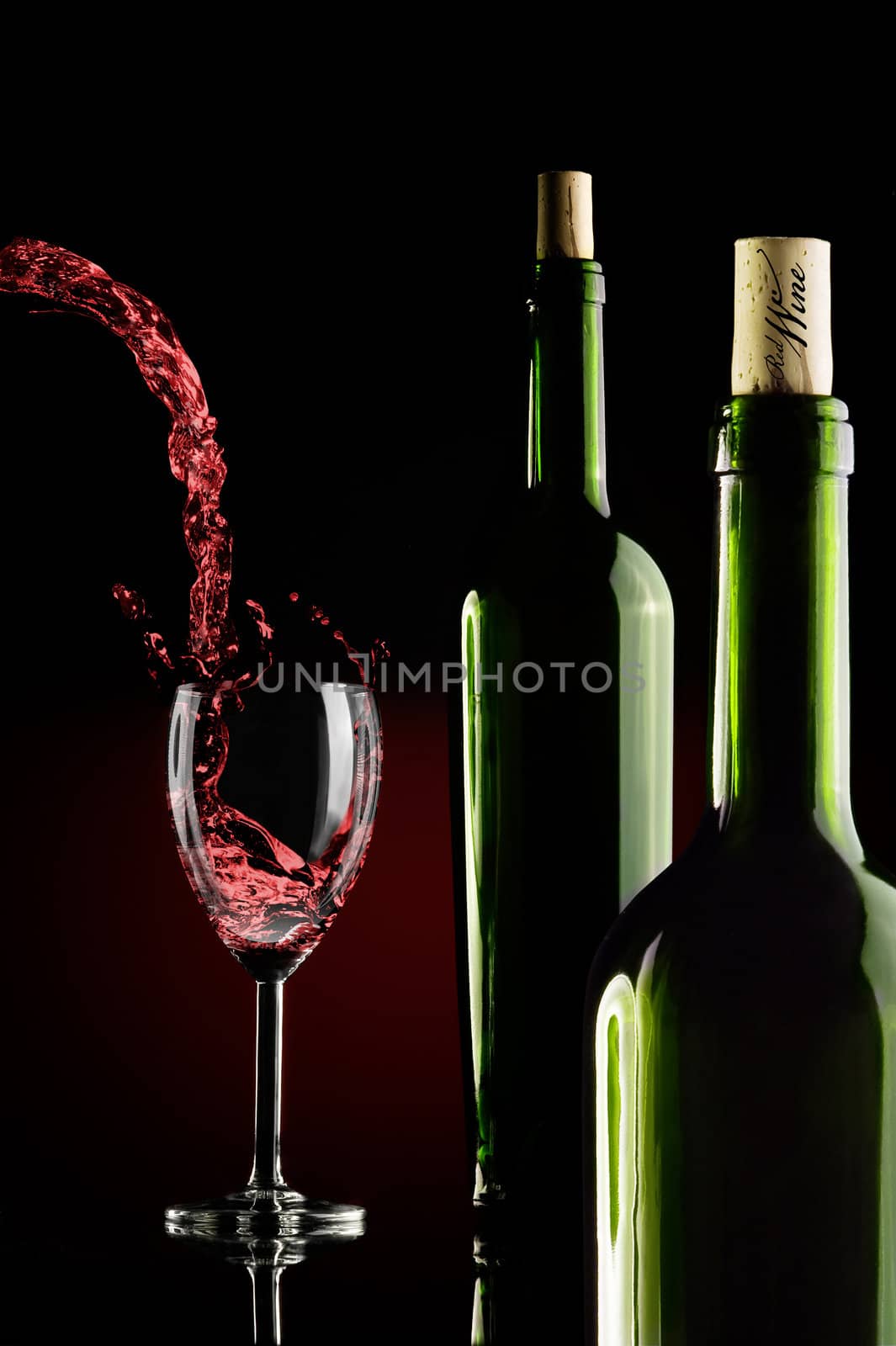 two bottles and a glass of wine over gradient backround