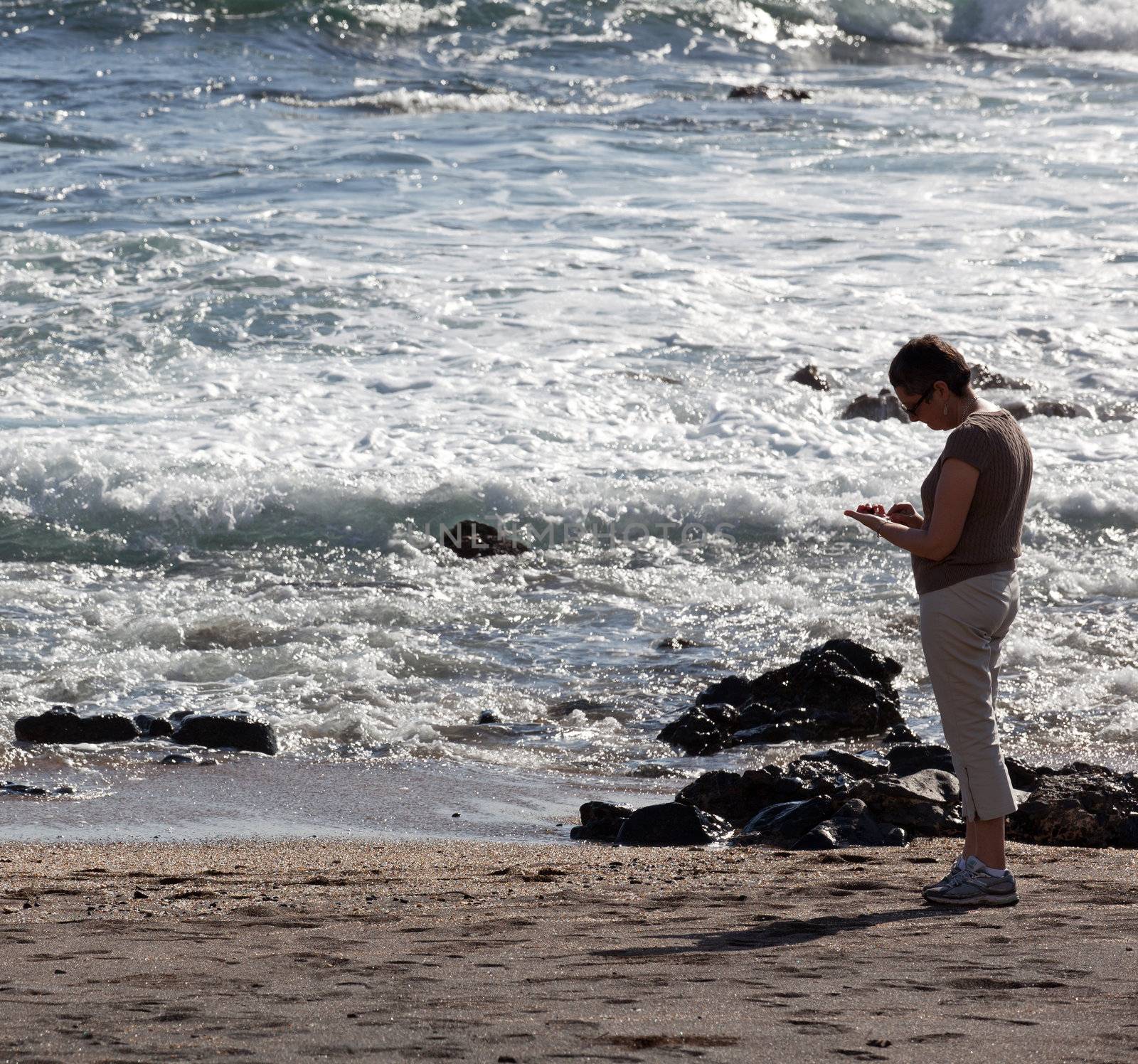 Woman beachcombing on Glass Beach in Kauai