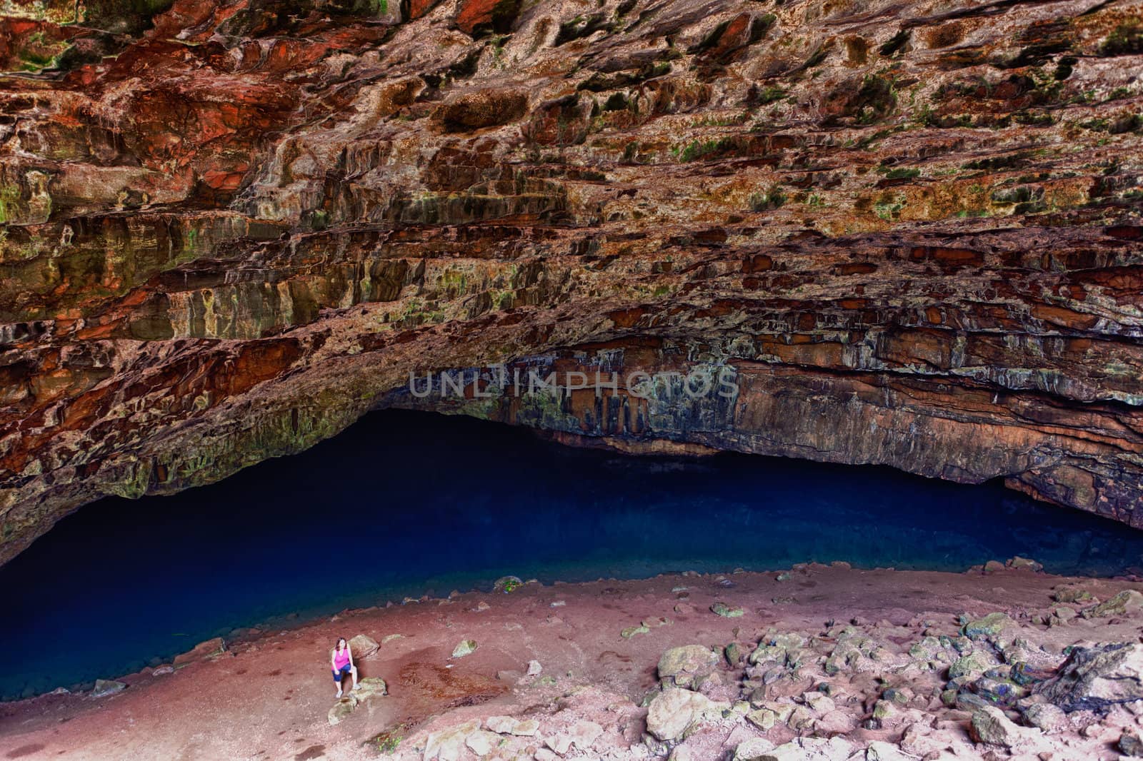 Waikapalae wet cave with female hiker in Kauai. Cave used in Pirates of Caribbean