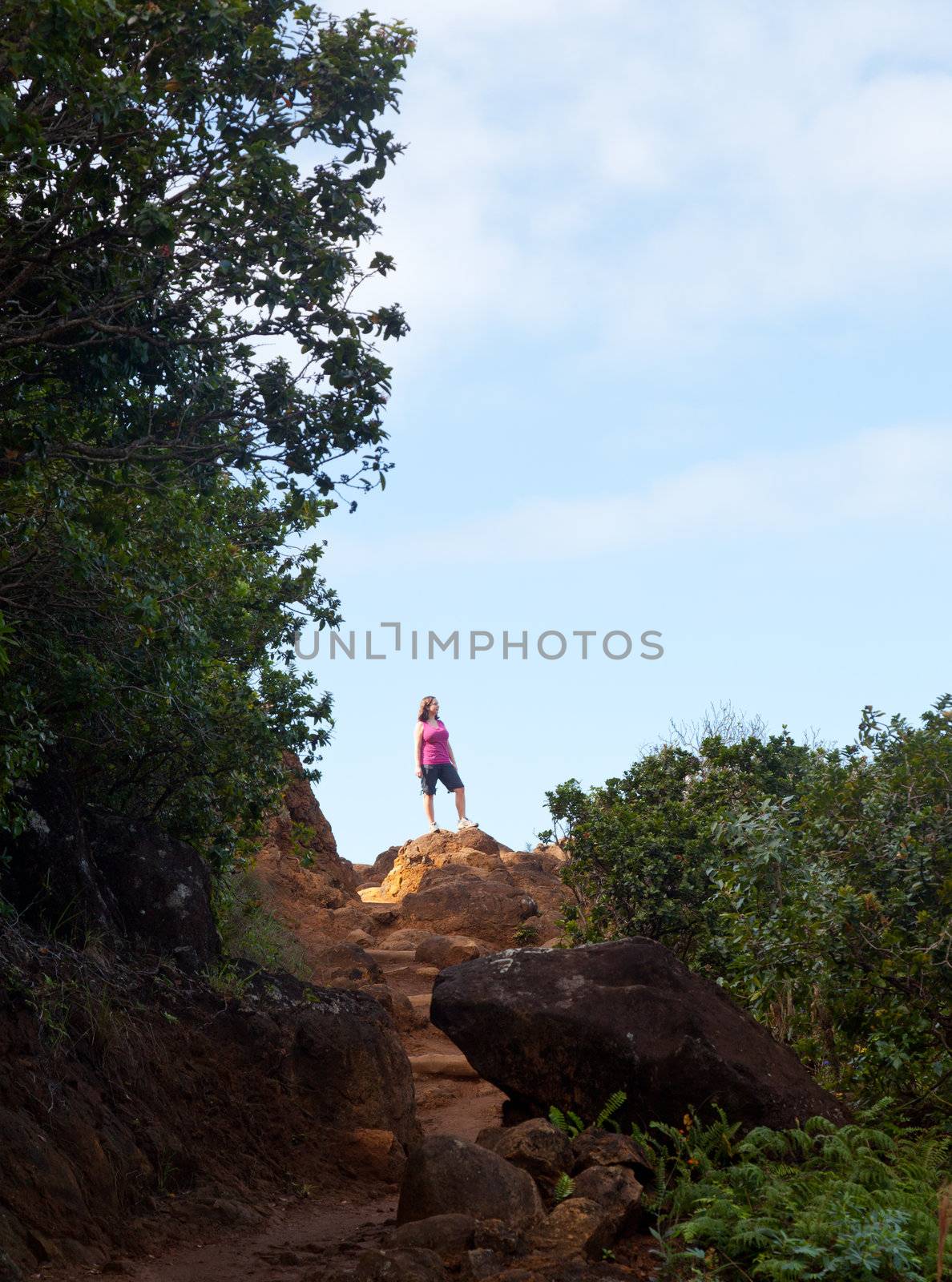 Girl hiking Kalalau trail in Kauai by steheap