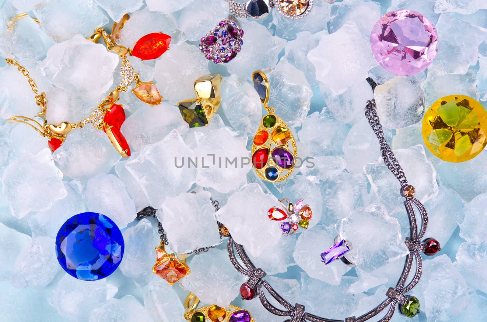 Jewels at blue cube of ice background