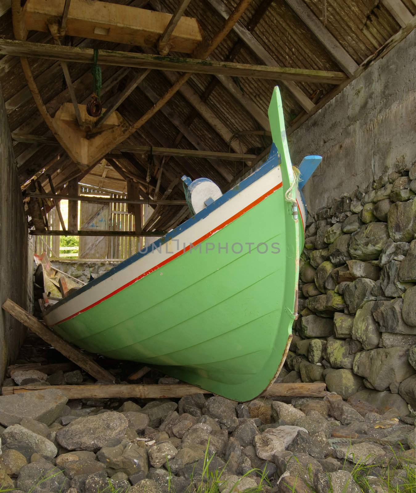 Traditional Faroese fishing boat made ​​of wood in an boathouse by jogvan