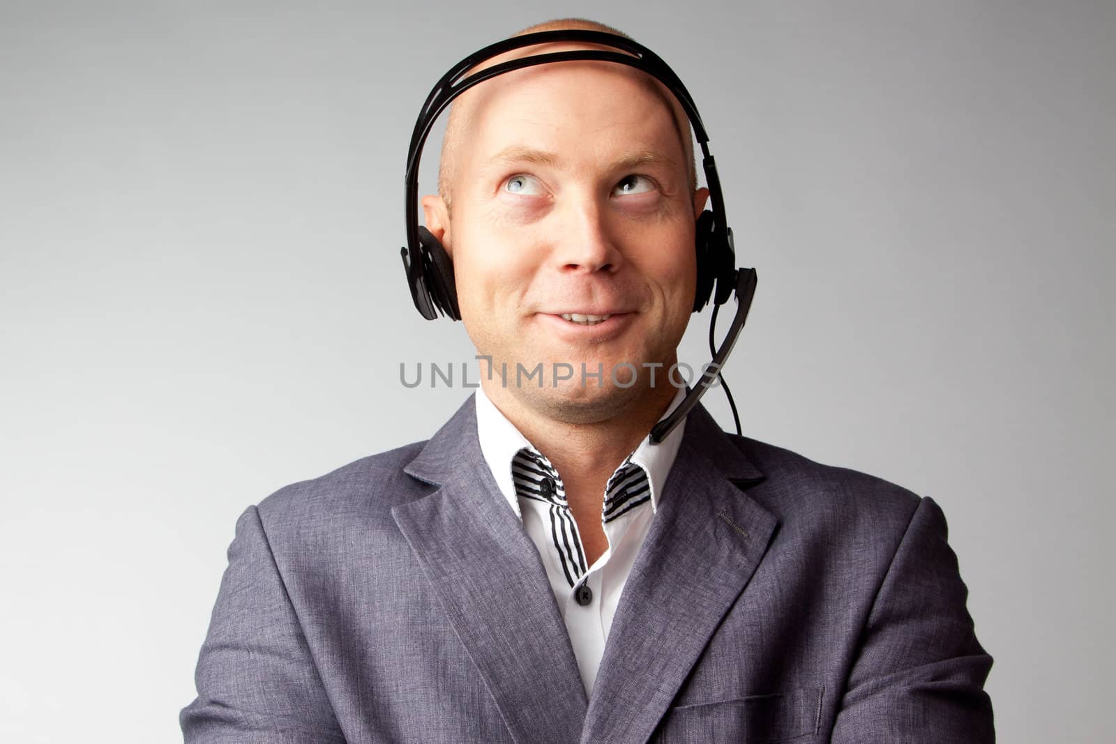Portrait of a young handsome man with a headset on his head, who works in customer service