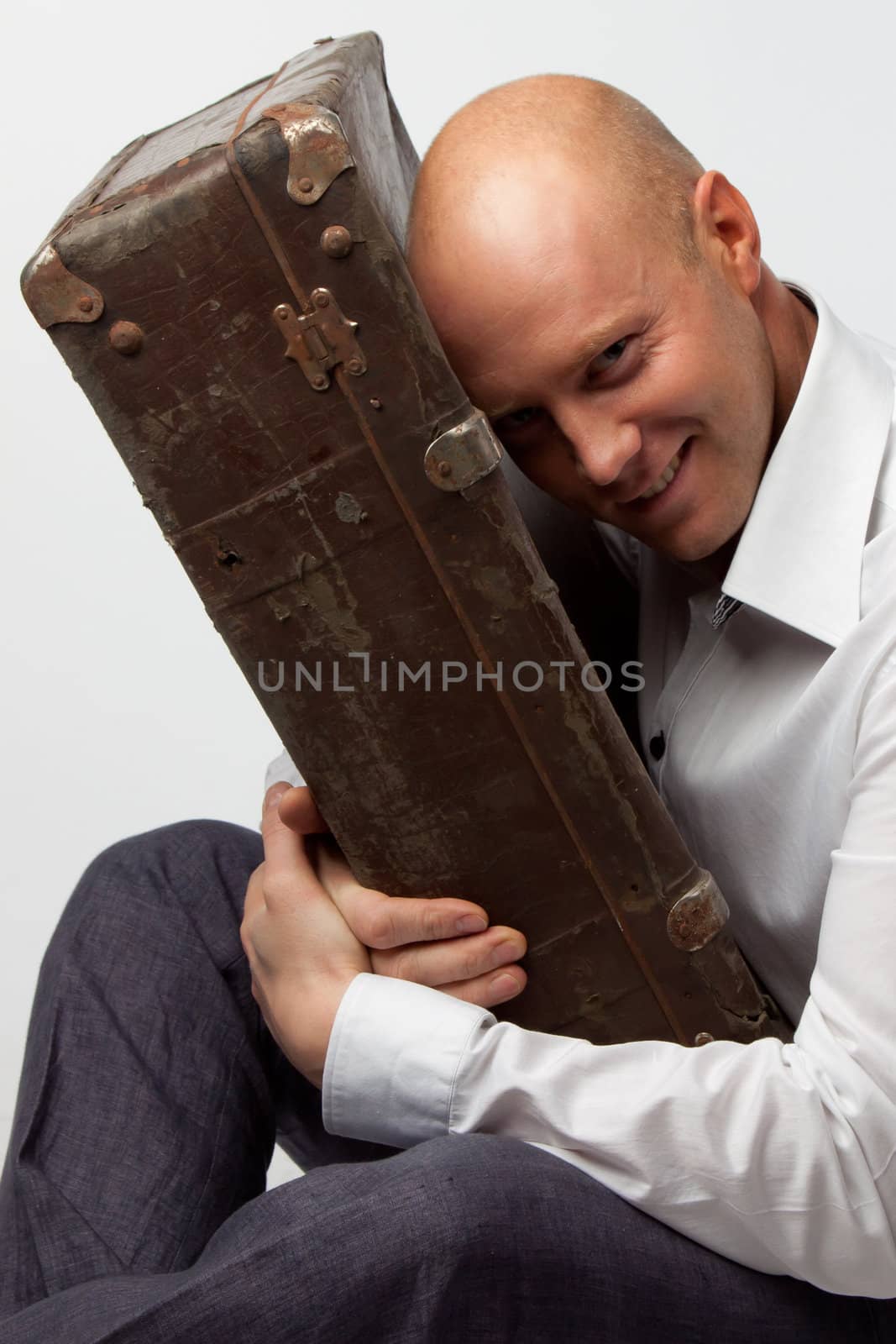Portrait of a man with an old suitcase