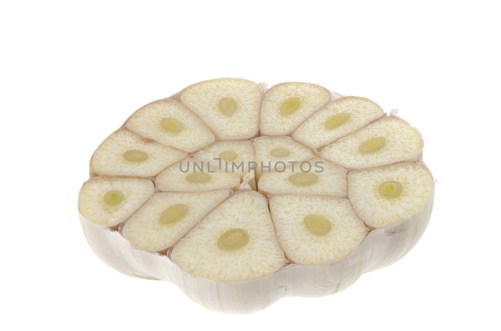 Garlic cut into half with the separate cloves showing - isolated on white
