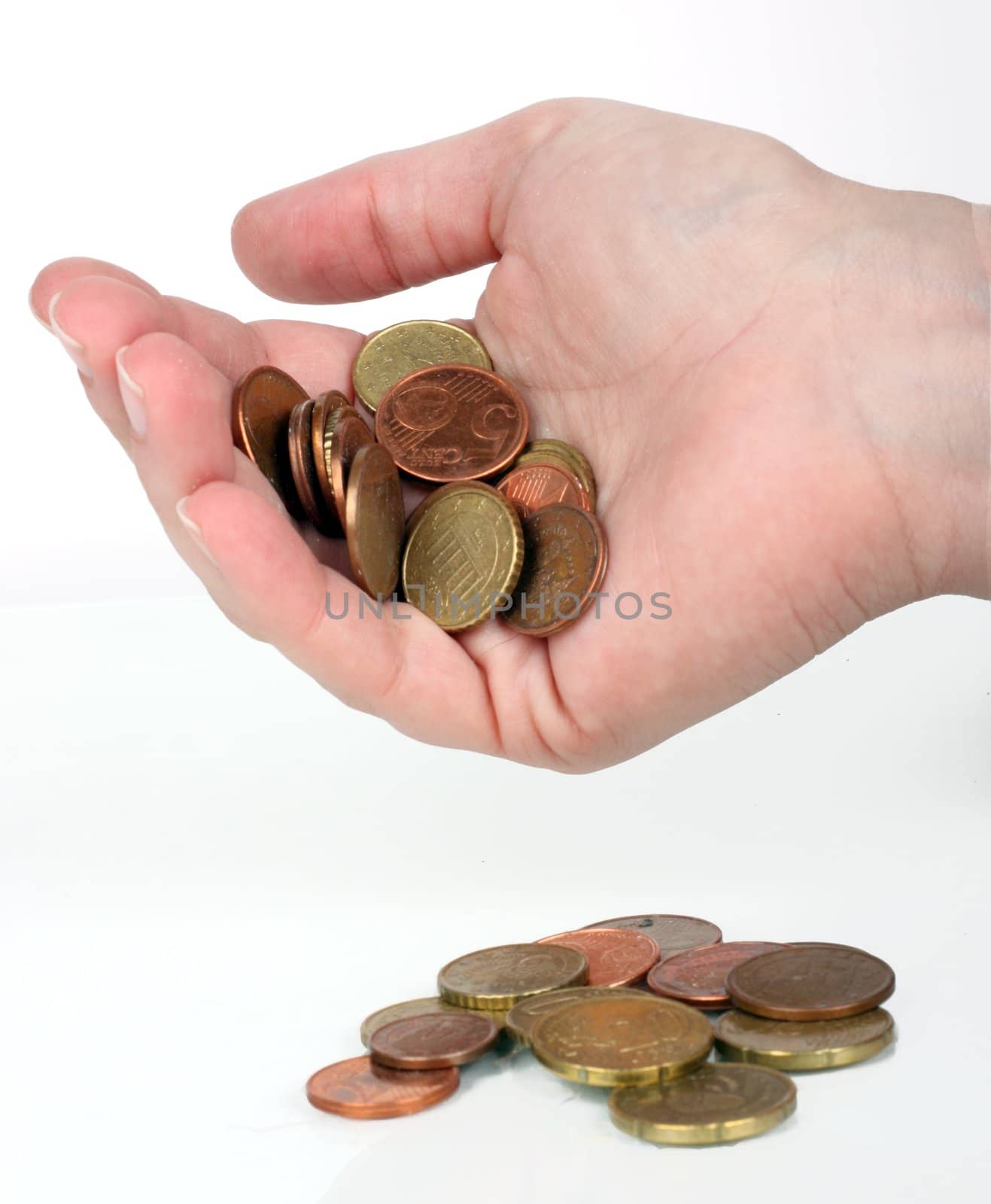 some euro coins falling from a human hand