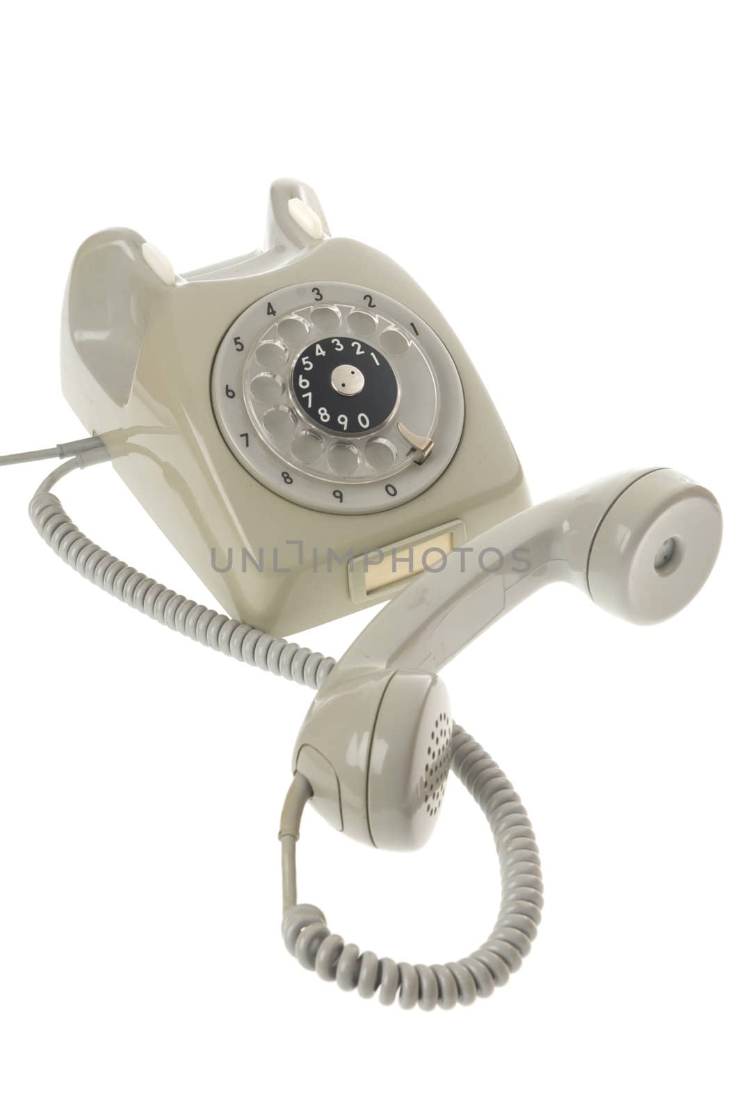 old gray vintage rotary style telephone off the hook -  solated on white
