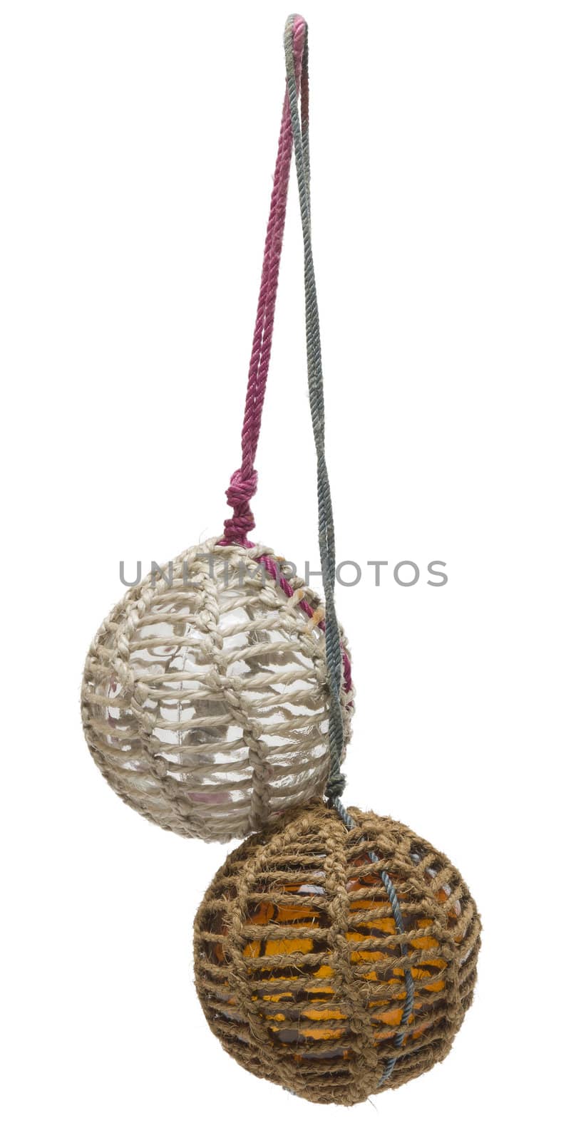 Glass fishing buoy used to keep fishing nets floating. These are old glass antique. Isolated on white background.