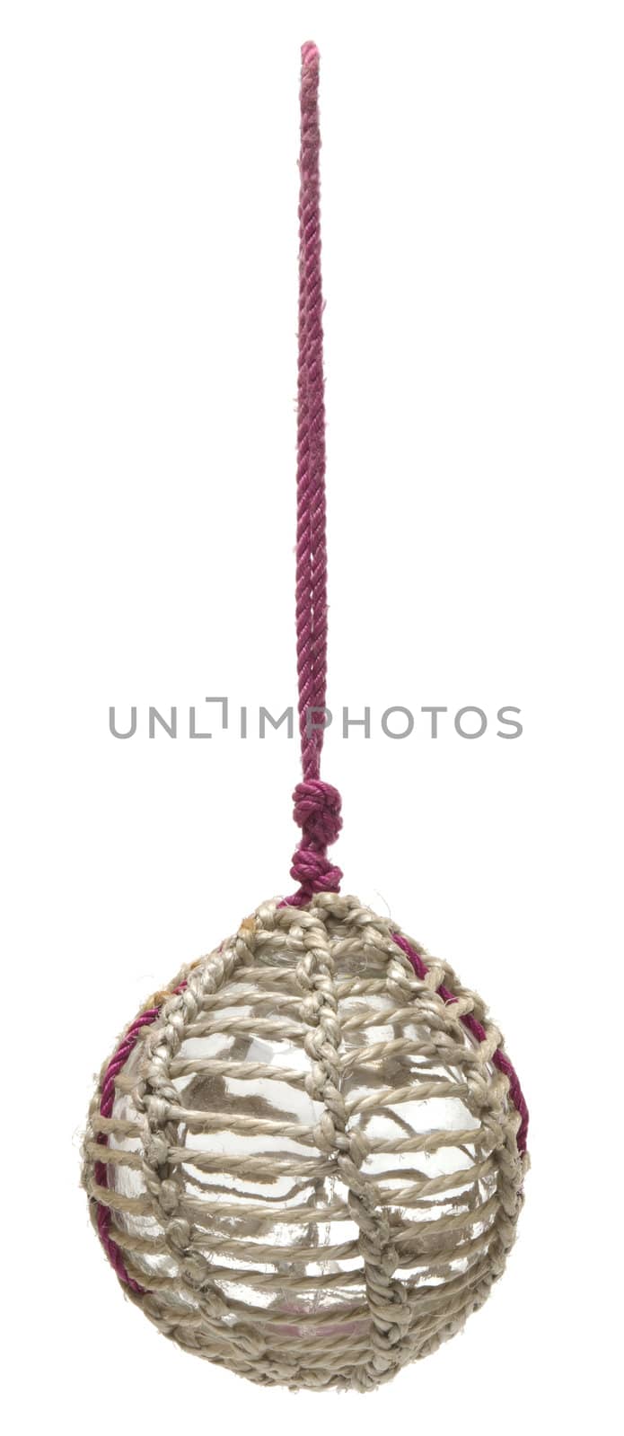 Glass fishing buoy used to keep fishing nets floating. This is an old glass antique. Isolated on white background.