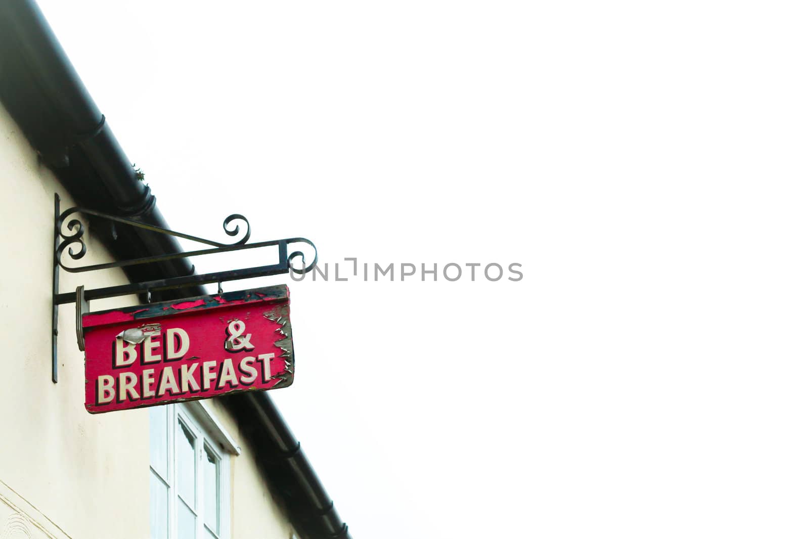 Bed and breakfast sign on a traditional english cottage with a white background