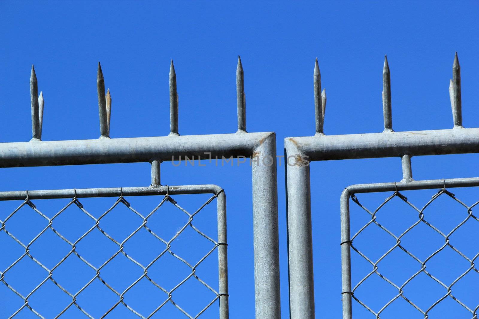 Close up of iron grey fence in blue byckground