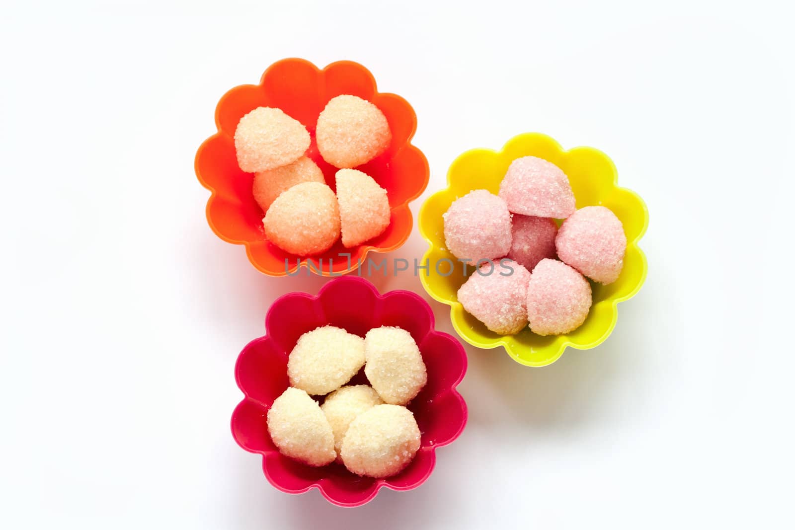 sweet jelly candies in cup cake cases on white by sfinks