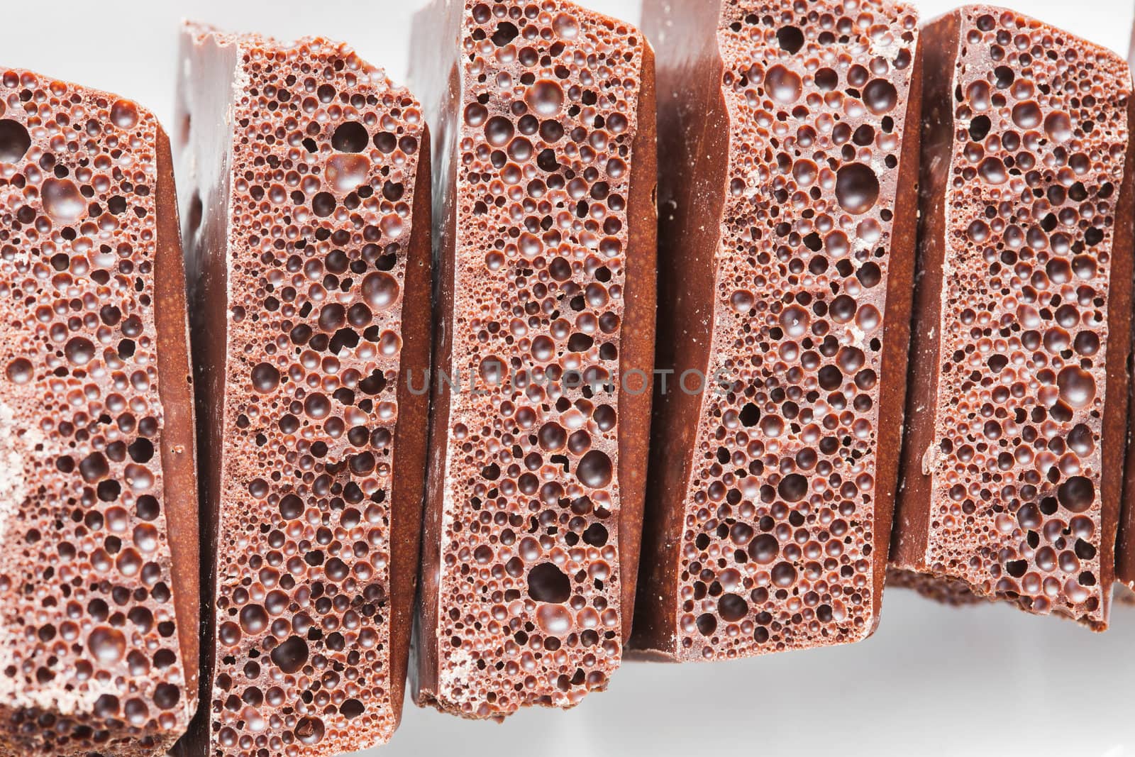 porous chocolate on a plate by sfinks