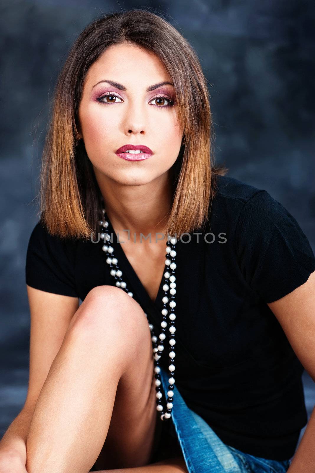 Portrait of a woman in black shirt on dark background