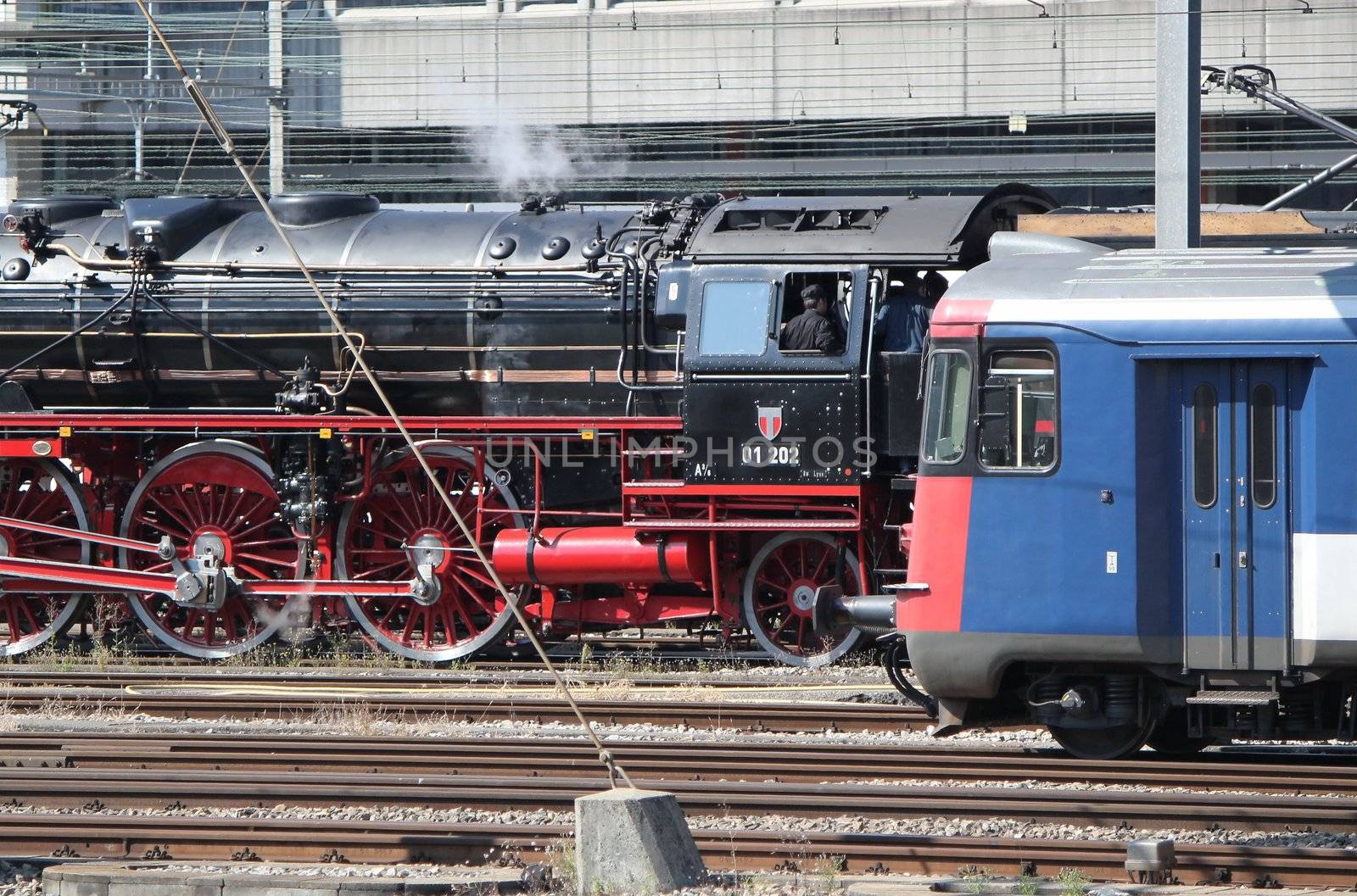 Old and modern locomotives in a train station