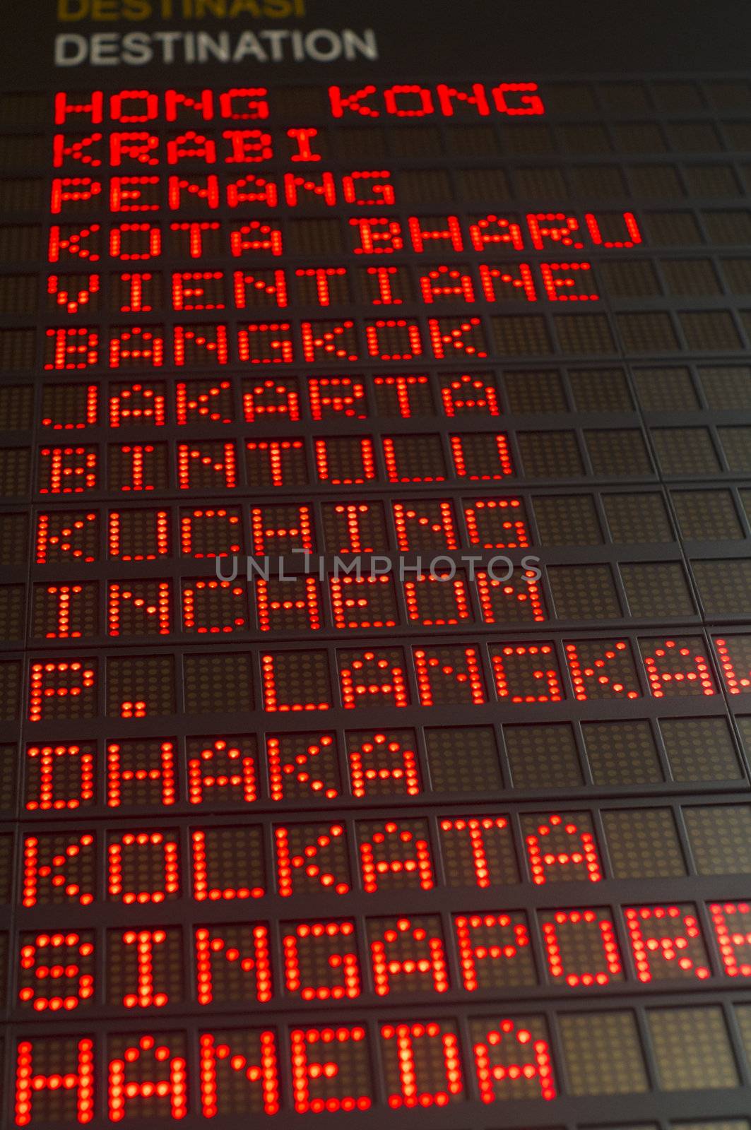 airport departures board that shows asian destinations.