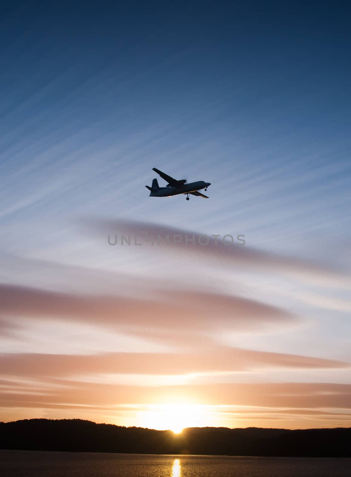 Airplane in sunset by ThomasOderud