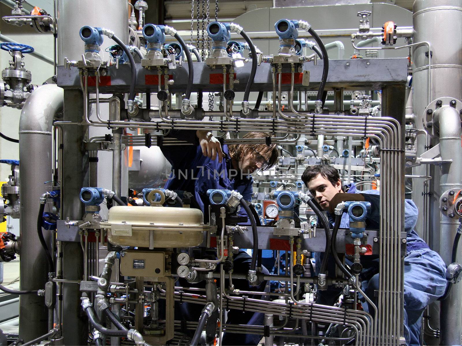 Two technician working on a machinery