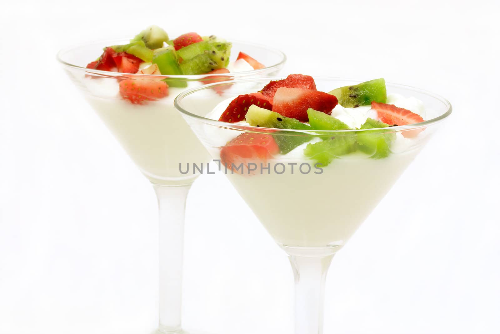 Two glasses of plain yogurt with fresh strawberries and kiwi