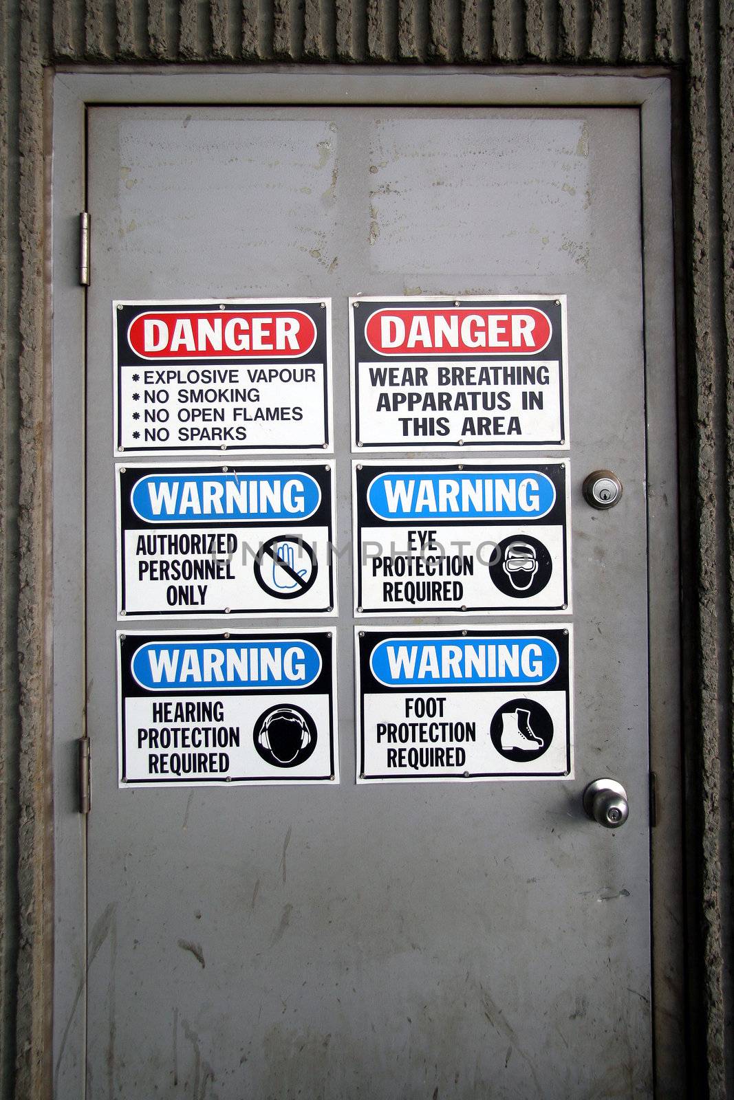 Indastrial doorway  with warning signs